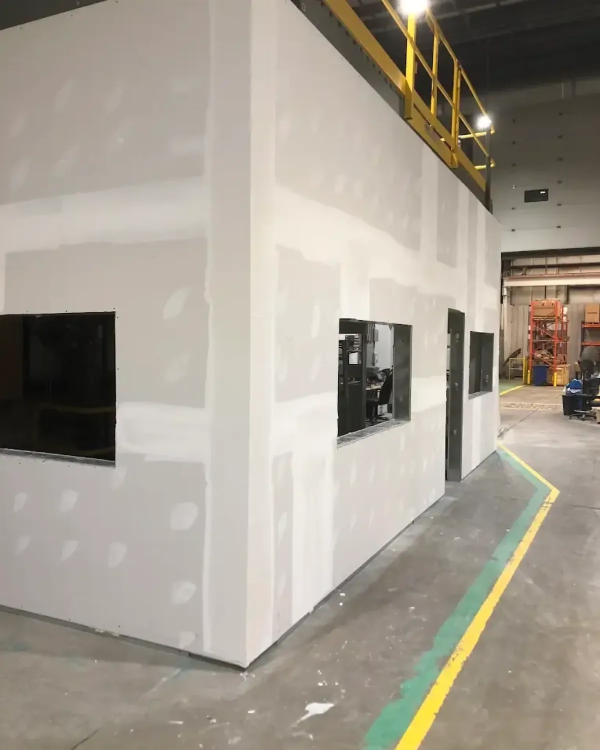 A drywalled office box inside an industrial plant with taped and mudded joints