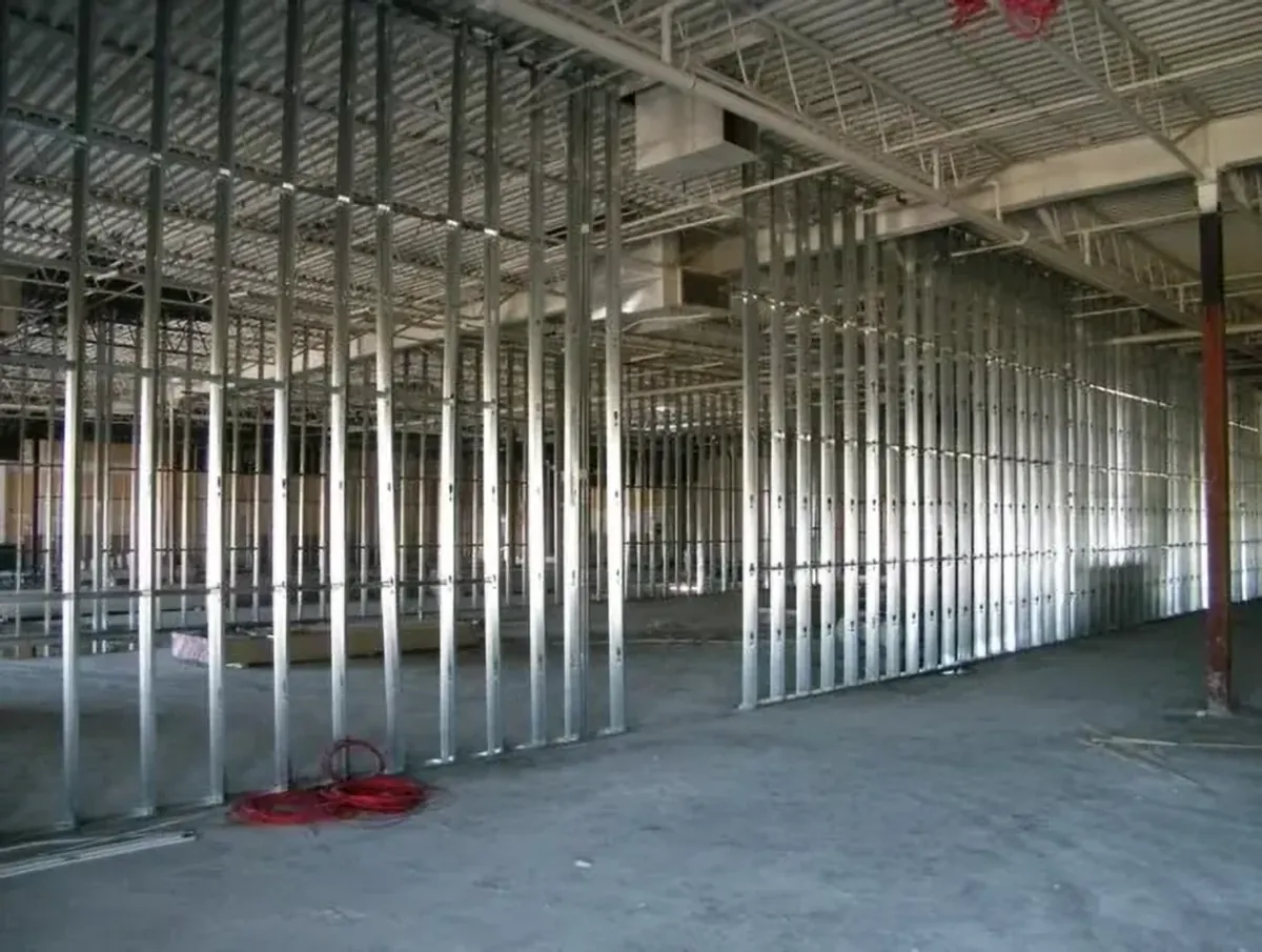 Steel stud walls framed out across a large open commercial floor